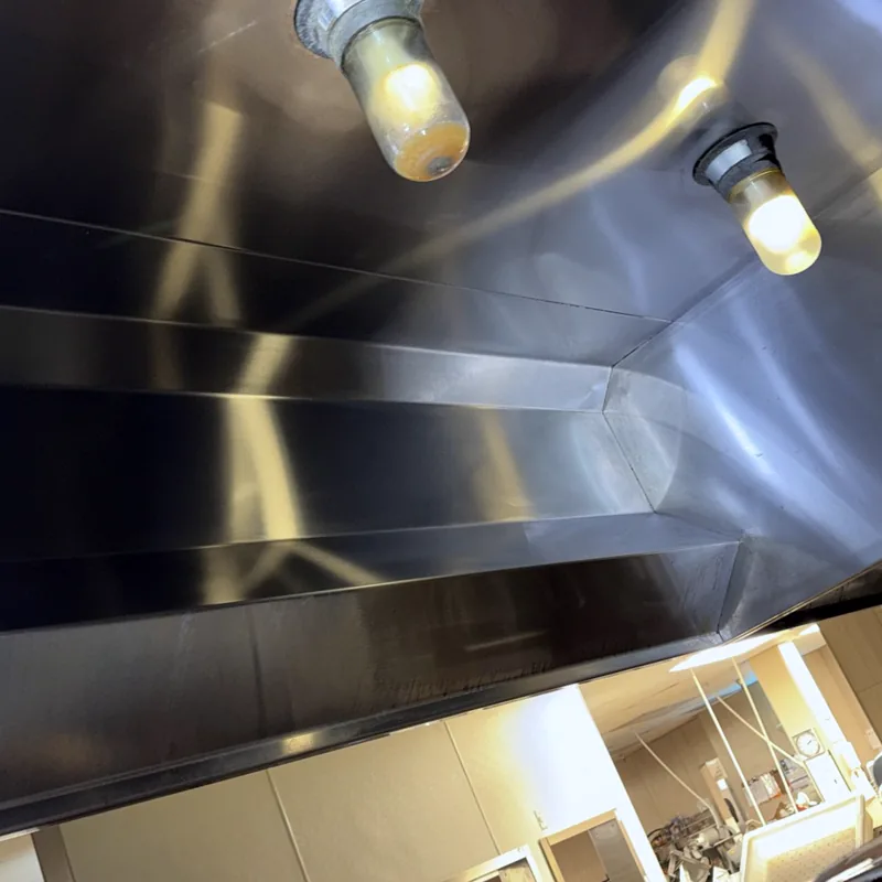 Grocery store hood interior after cleaning, bright clean stainless panels, Glenwood Springs.