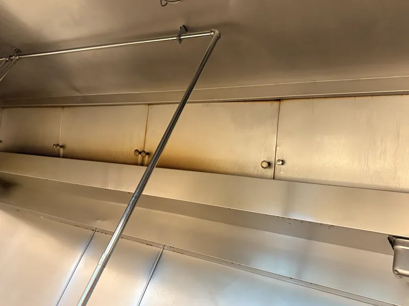 Corporate dining hood plenum before cleaning, dull grease film on the stainless panels, Centennial.