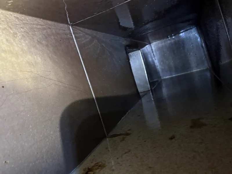 Entertainment venue exhaust duct after cleaning, walls and floor clean and shiny, Centennial.