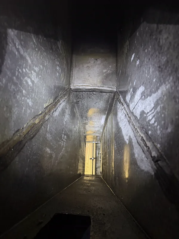 Hotel kitchen exhaust duct after cleaning, grease removed and bare metal showing, Cheyenne, Wyoming.