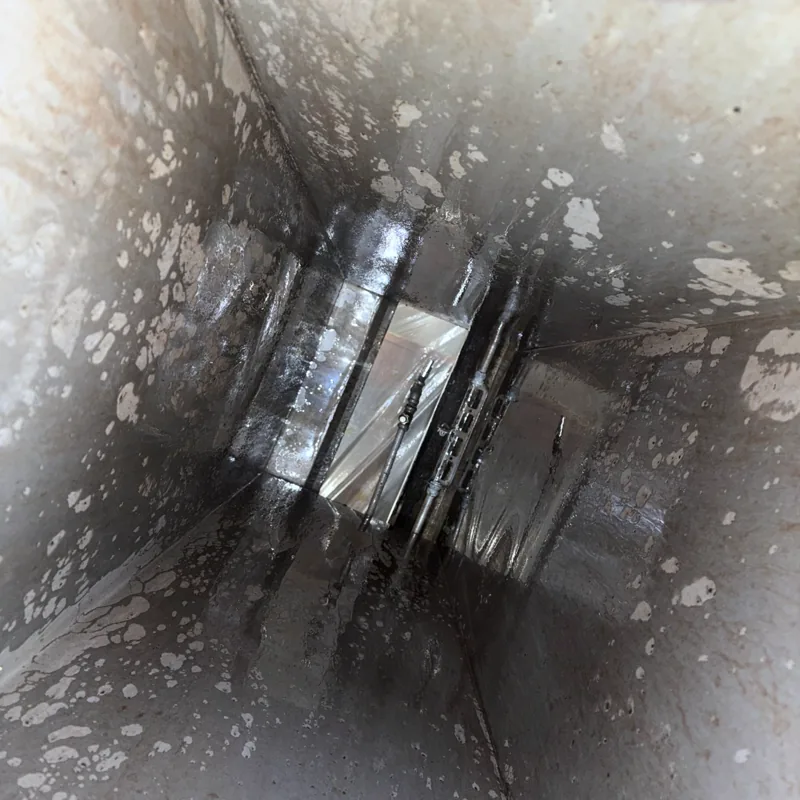 Restaurant exhaust duct after cleaning, interior cleaned to gray metal, Denver.