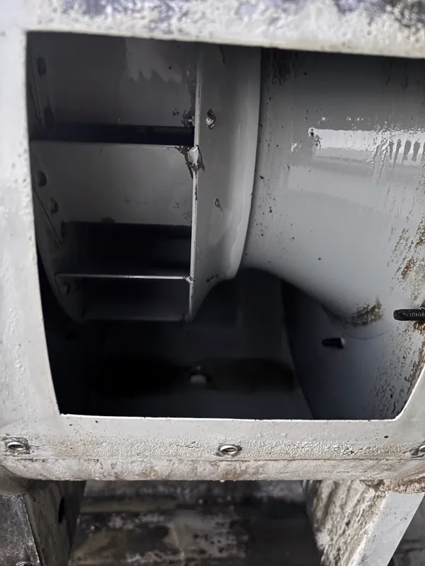 Stadium exhaust fan housing after cleaning, inner walls clean and bare, Denver.
