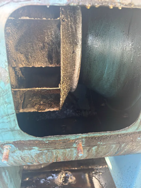 Stadium exhaust fan housing before cleaning, grease and grime coating the blades, Denver.