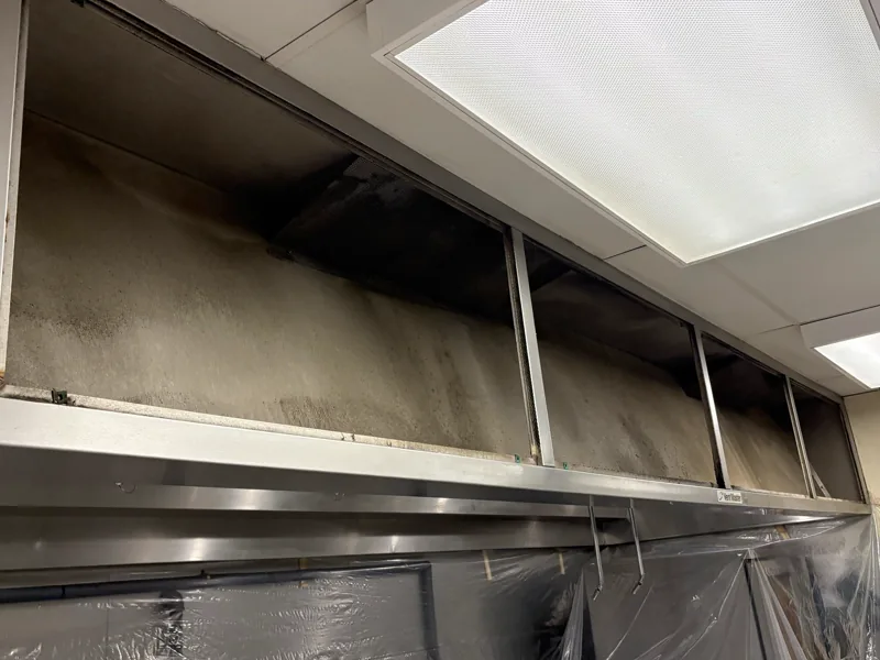 Corporate dining makeup air vent before cleaning, soot and grease darkening the housing, Centennial.